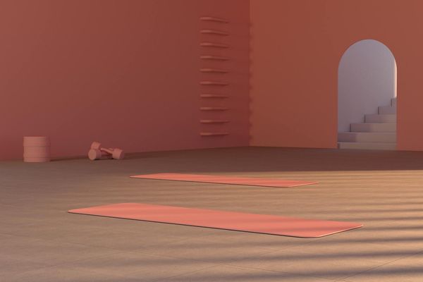 Clean and modern studio interior with soft lighting and exercise mats.